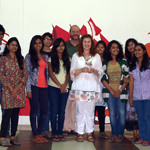 Theresa and Paul Richardson group photo with students in front of their finished workshop abstract compositions